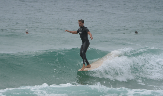 Noseriding a sustainably made hollow-wooden longboard surfboard