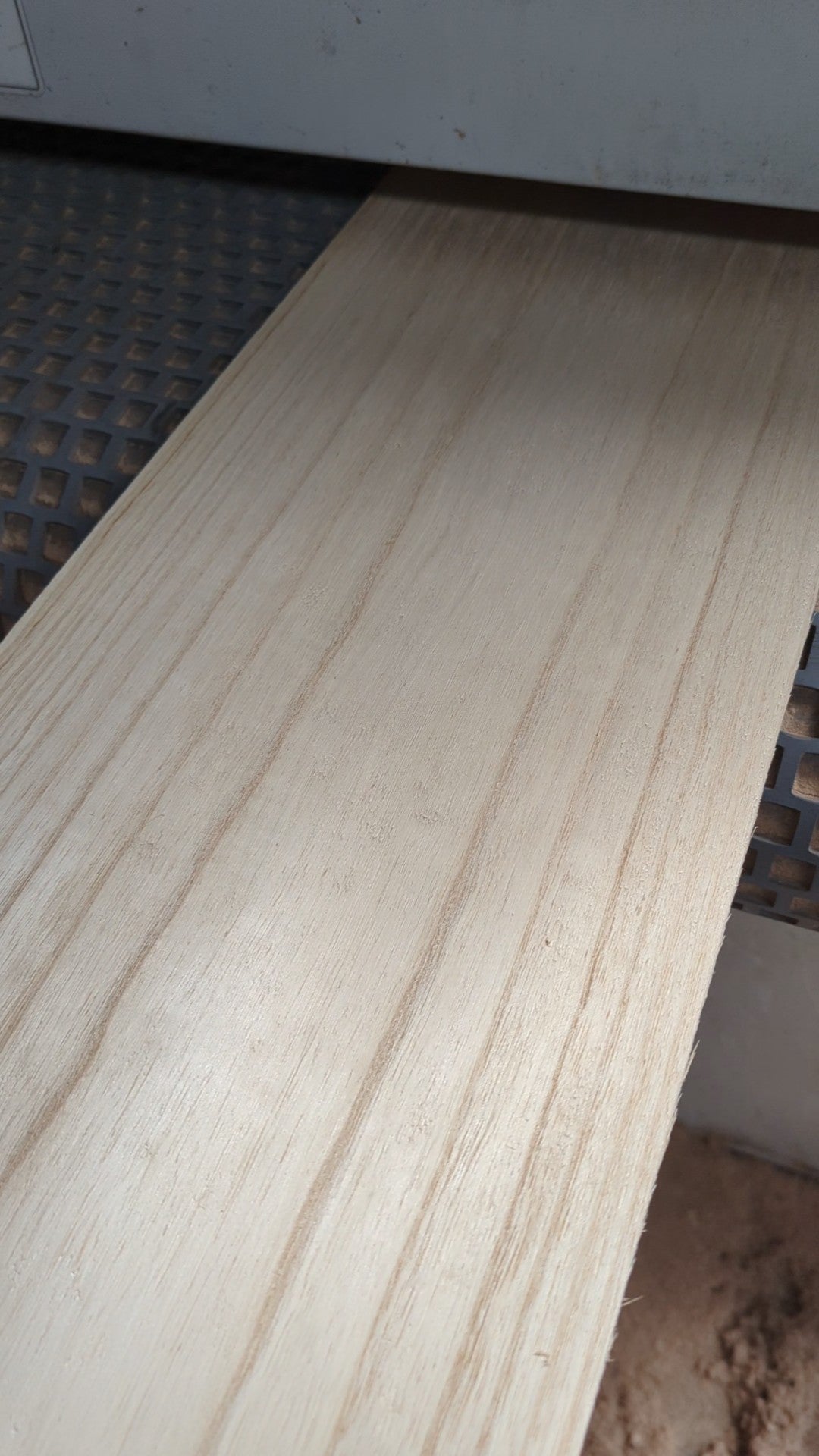 Paulownia surfboard skin coming out of the sanding machine