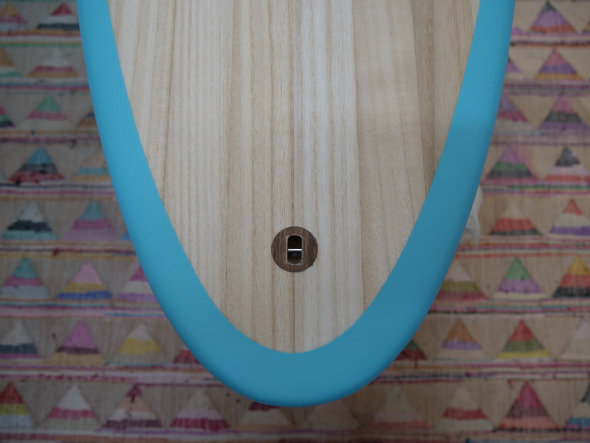 Strider tail with a vented wooden leash plug and teal rail