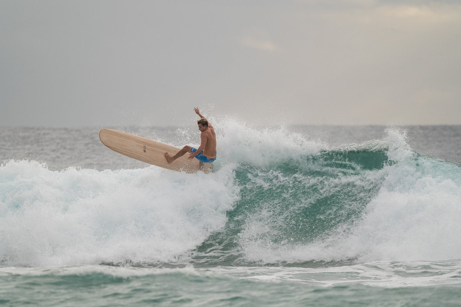Declan Wyton surfing an environmentally friendly Sine Surf hollow wooden surfboard